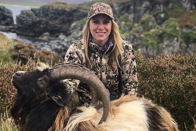 Larysa Switlyk poses with a dead goat