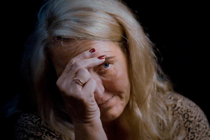 Nicola Gobbo places her hands over her face.