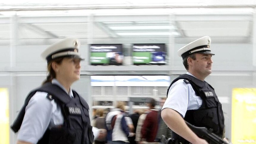 German police officers patrol the departure area of Munich's airport