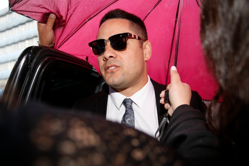 A man walking under an umbrella 