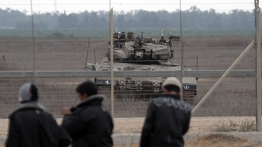 An Israeli army tank in position along border with Gaza