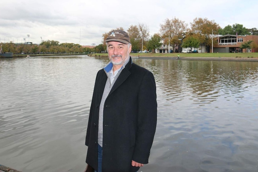 Yarra riverkeeper Andrew Kelly stands beside the banks of the Yarra River in Melbourne, opposite the rowing club sheds