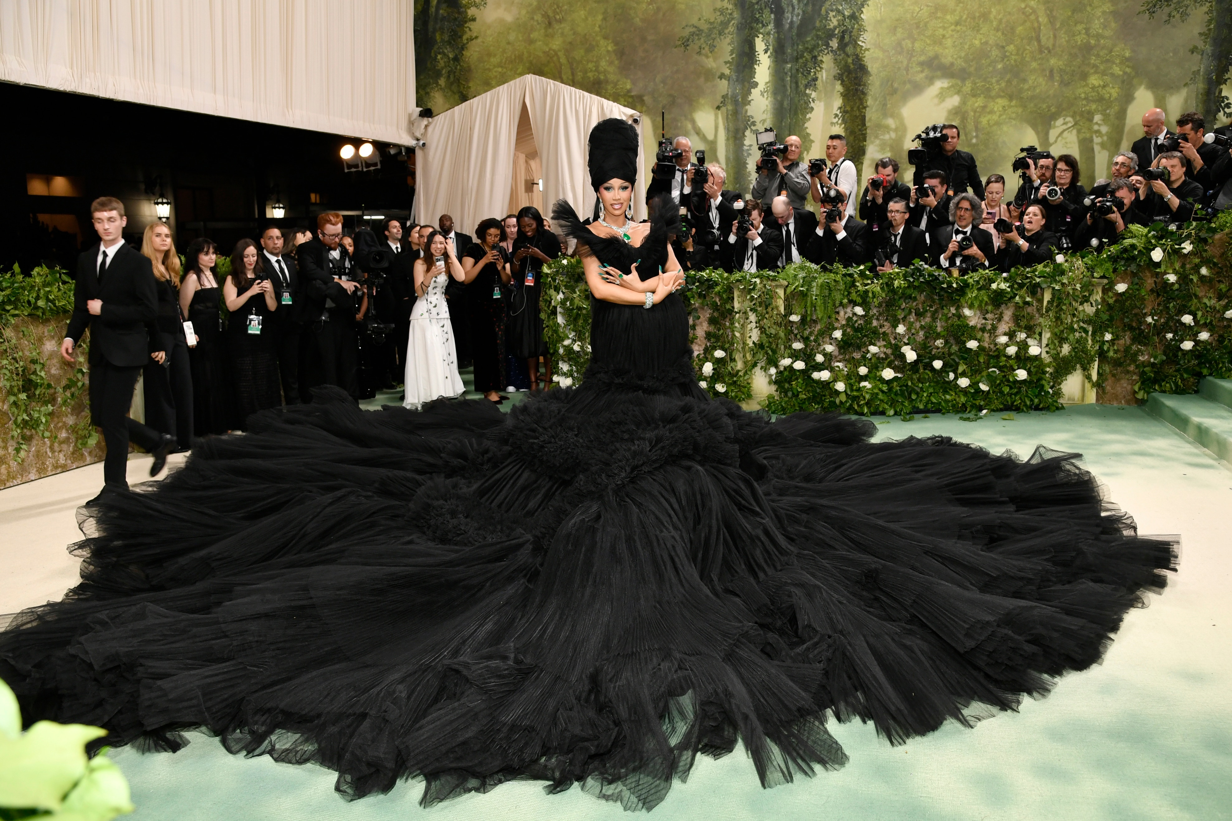 Cardi B wearing a black tulle off-the-shoulder dress with a skirt that has about a 4-metre radius.