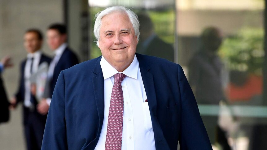Businessman Clive Palmer smiles as he leaves the Supreme Court in Brisbane.