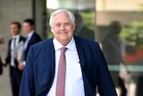 Businessman Clive Palmer smiles as he leaves the Supreme Court in Brisbane.