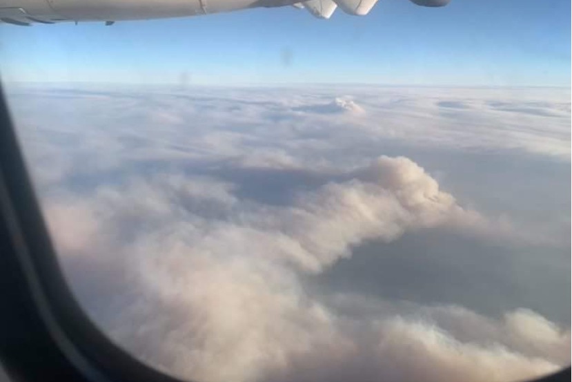 Large bushfire smoke clouds are captured in a picture from a plane