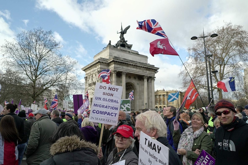 Protesters with placards march through central London campaigning for a hard Brexit.