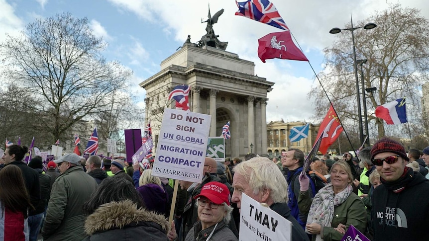 Protesters with placards march through central London campaigning for a hard Brexit.