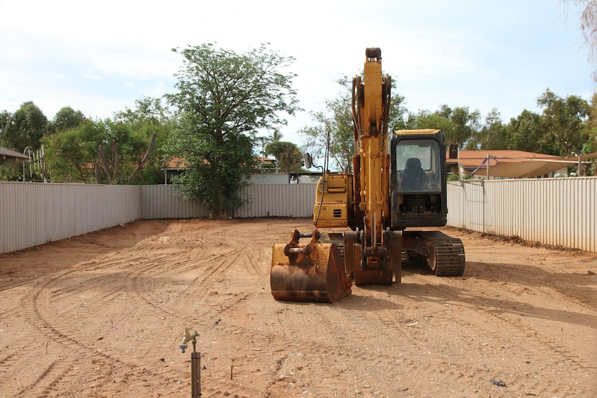A cleared block of land with heavy machinery on site.