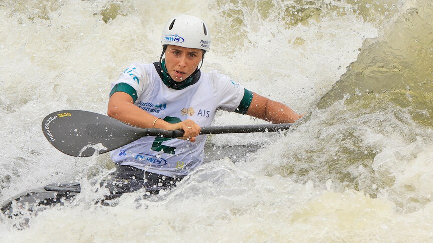 Noemie Fox is concentrating while canoeing through wild water