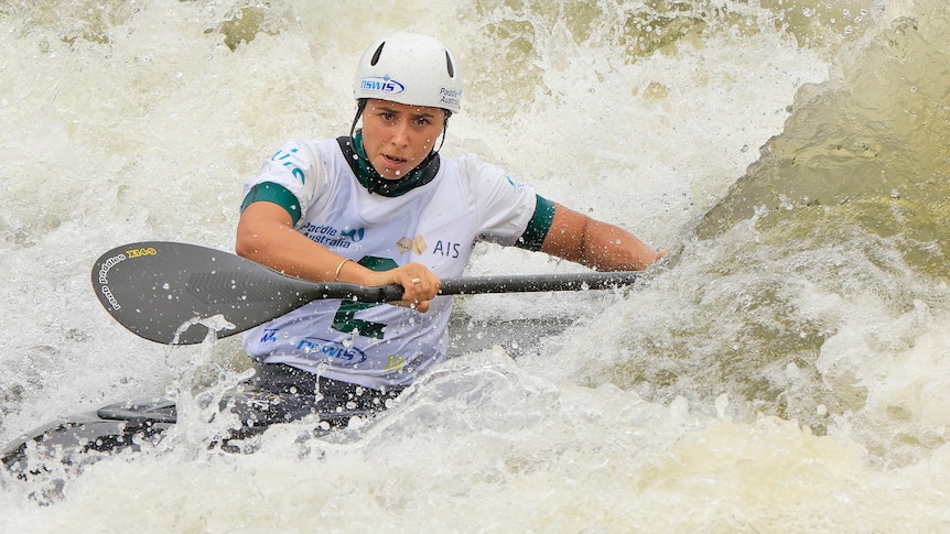 Noemie Fox is concentrating while canoeing through wild water