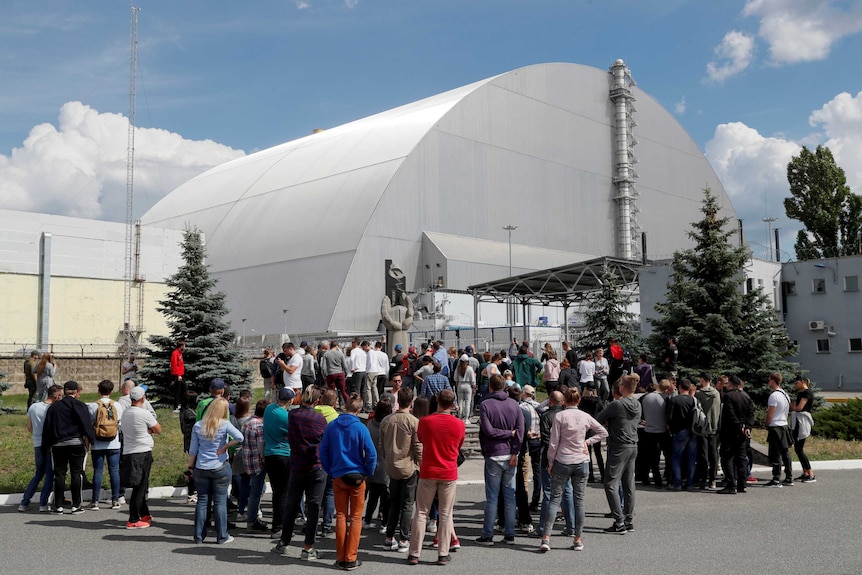 visitors outside the New Safe Confinement structure in Chernobyl