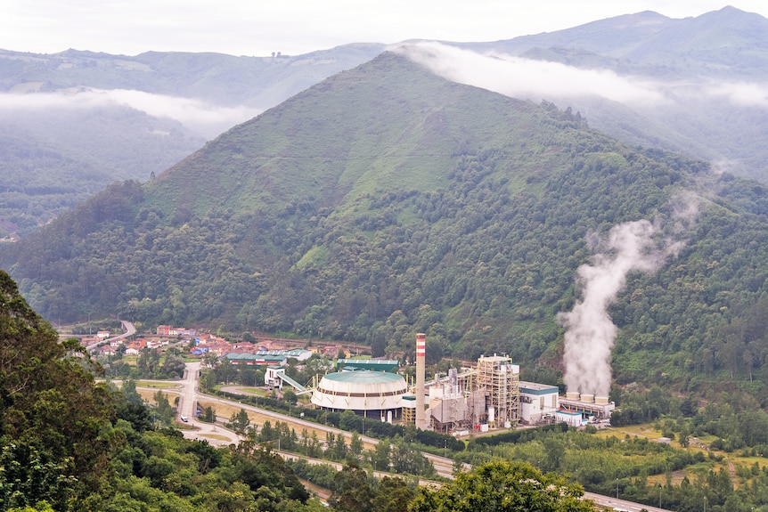 A coal plant in a valley.