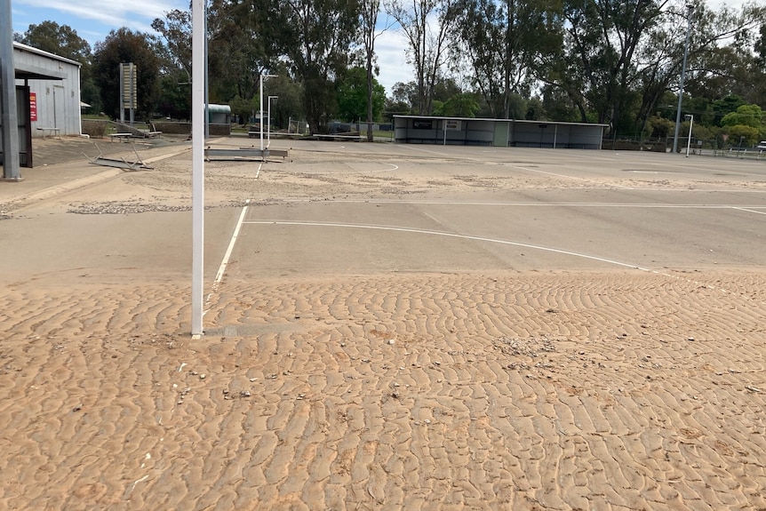 Sand and dirt lay on netball courts.