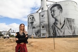 Russian artist Julia Volchkova standing in front of her silo art work at Rupanyup in western Victoria.