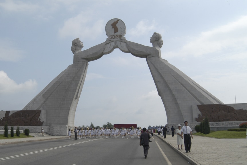 A monument of two women holding hands together in North Korea. 