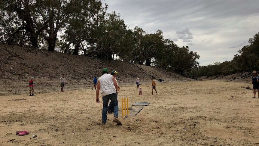 Residents of Wilcannia participate in a game of cricket where the Darling River has run dry.
