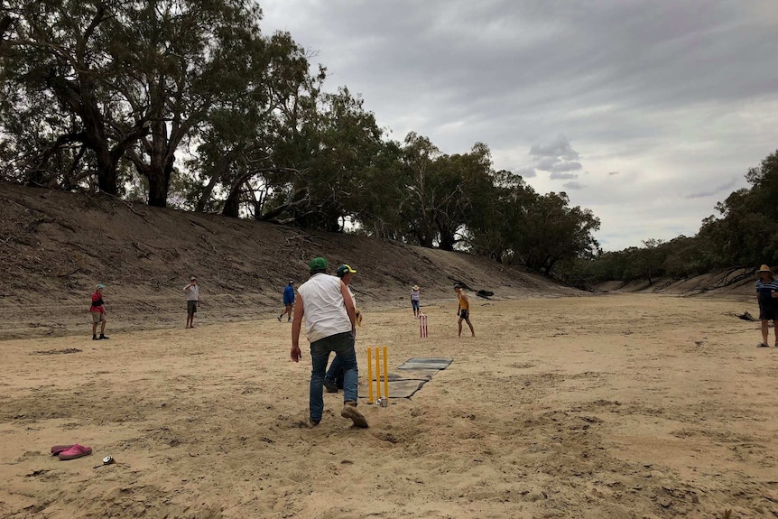Residents of Wilcannia participate in a game of cricket where the Darling River has run dry.