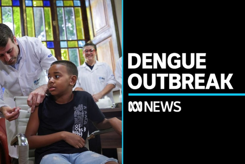 Dengue Outbreak: Man in white coat administers vaccine to seated child