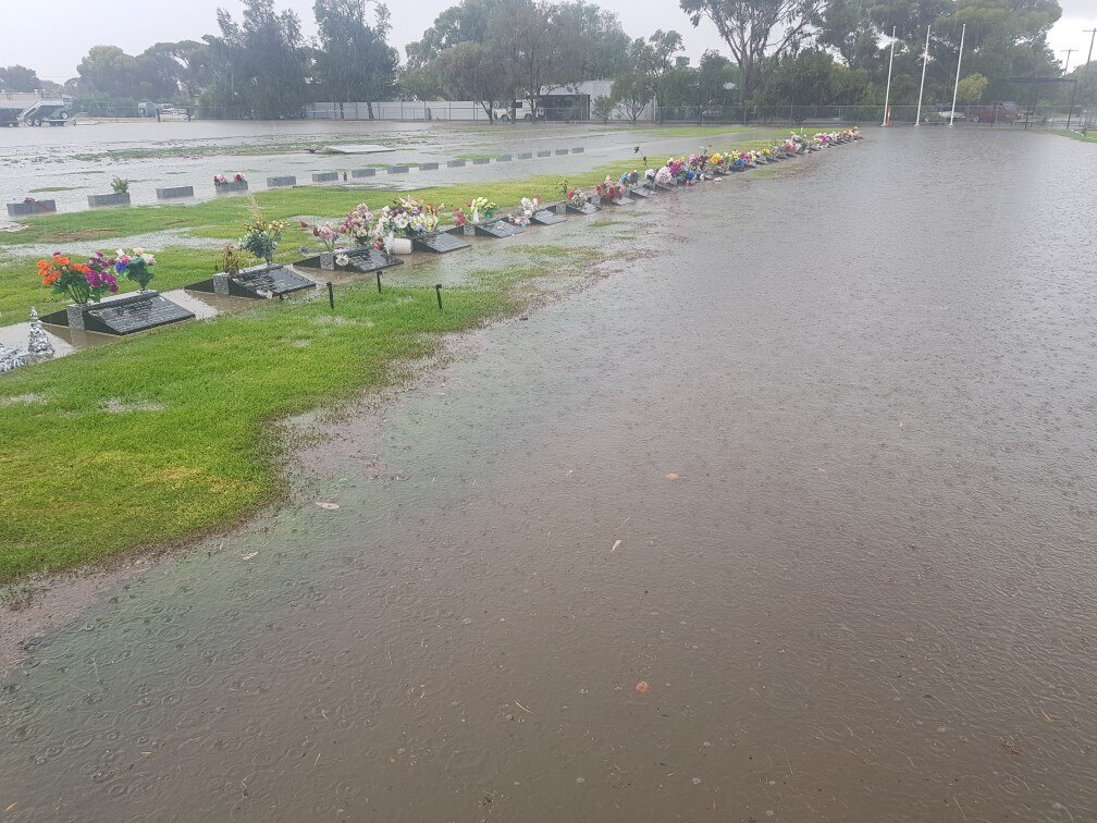 Water covers a large part of the cemetery grounds with headstones poking through 