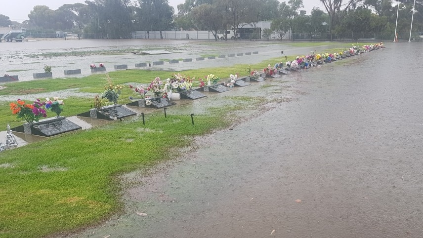 Water covers a large part of the cemetery grounds with headstones poking through 