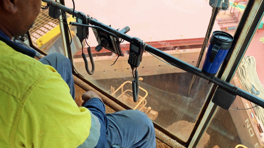 The view from the glass box on the end of the iron ore conveyor belt, looking into the hatch of the ship.