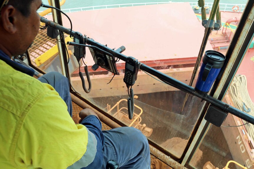 The view from the glass box on the end of the iron ore conveyor belt, looking into the hatch of the ship.