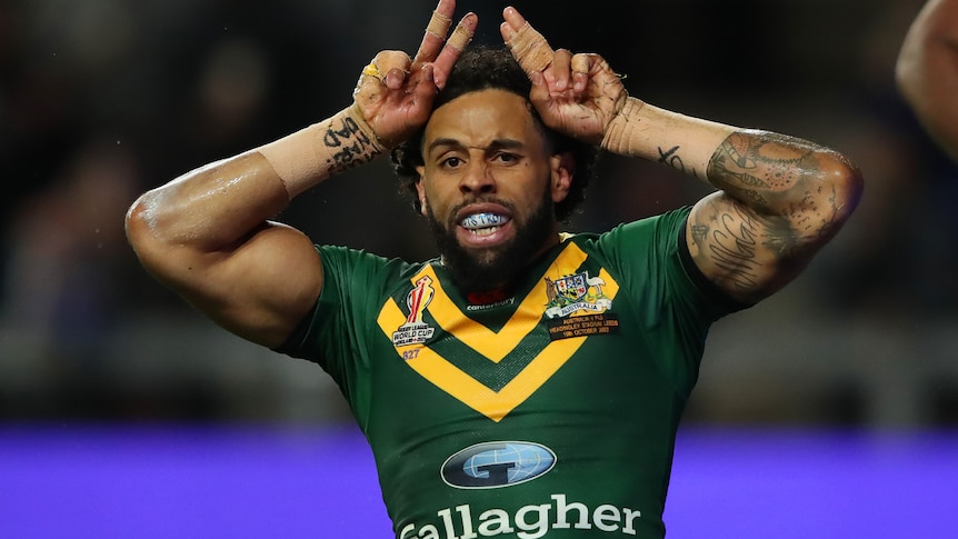 A man celebrates after scoring a try