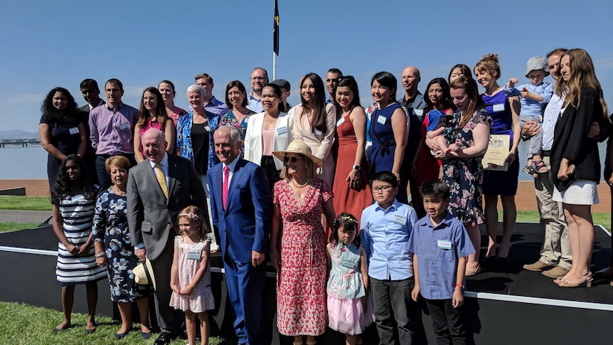 People who have been granted citizenship at the Australia Day citizenship ceremony in Canberra along side Malcom Turnbull