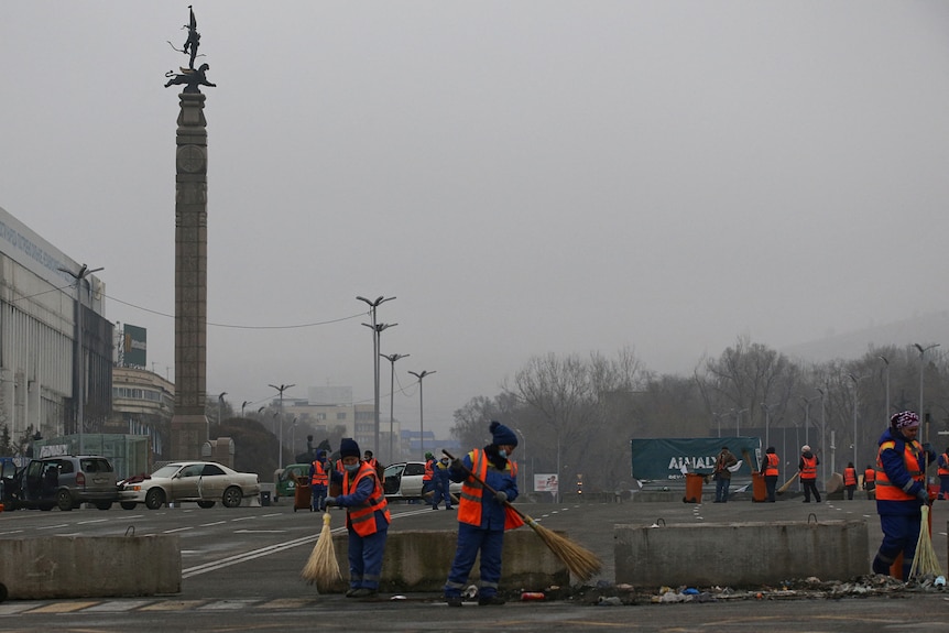 Municipal workers clean the streets of the main square after mass protests, January 10, 2022.