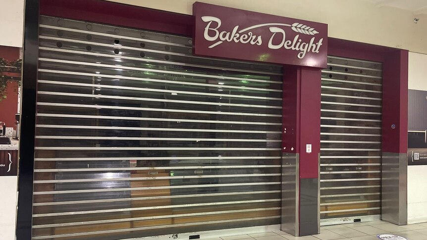 bakery with maroon signage and roller doors down