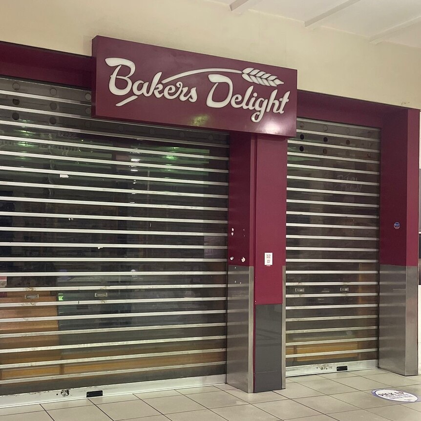 bakery with maroon signage and roller doors down