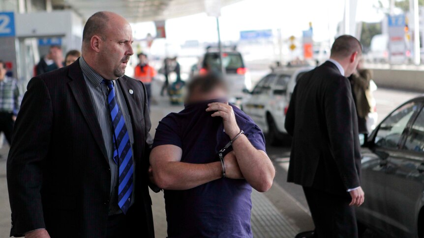 Beheading suspect arrives at Sydney Airport