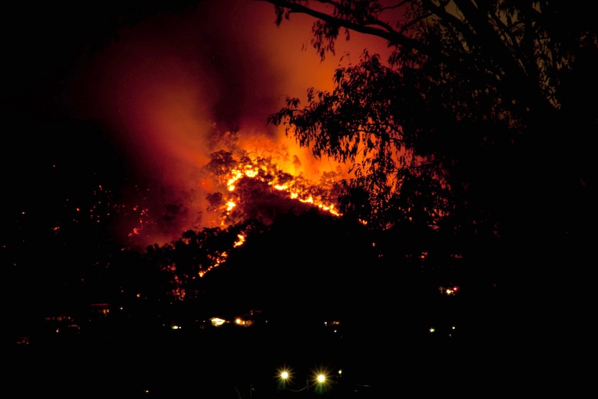 A bushfire burns after a controlled burn breached containment lines.