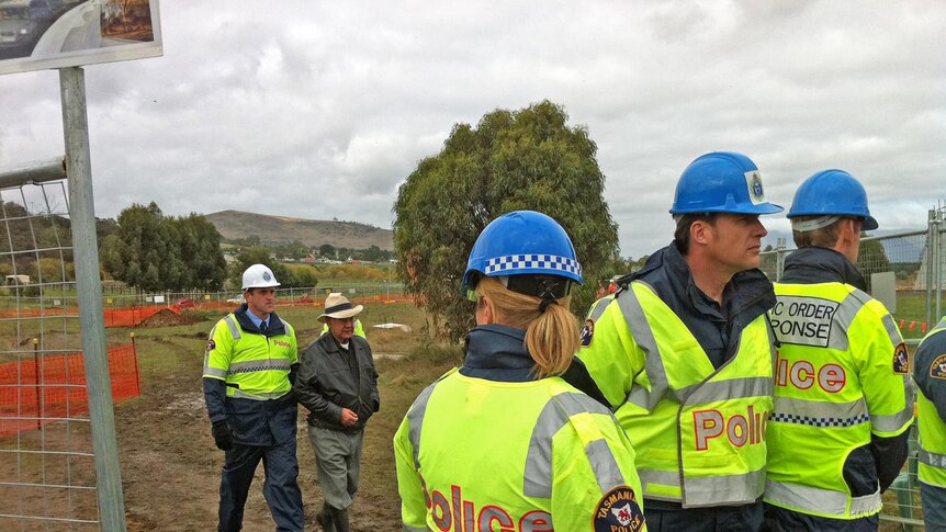 Tasmanian police remove an Aboriginal protester from the Brighton bypass construction site.