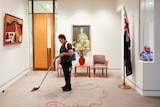 A cleaner vacuuming the Prime Minister's office at Parliament House in Canberra.