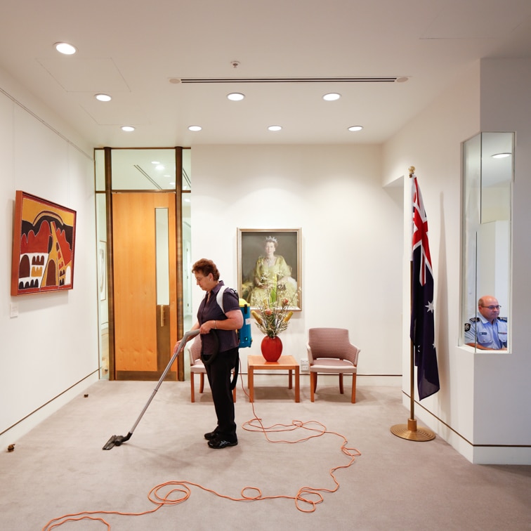 A cleaner vacuuming the Prime Minister's office at Parliament House in Canberra.