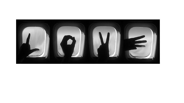 Four images of silhouetted hands spelling out L-O-V-E