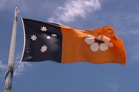 The Northern Territory flag features the southern cross and a stylised floral emblem in the territory's official colours.