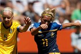 Sweden's Caroline Seger and Australia's Lisa de Vanna in action in 2011 Women's World Cup.