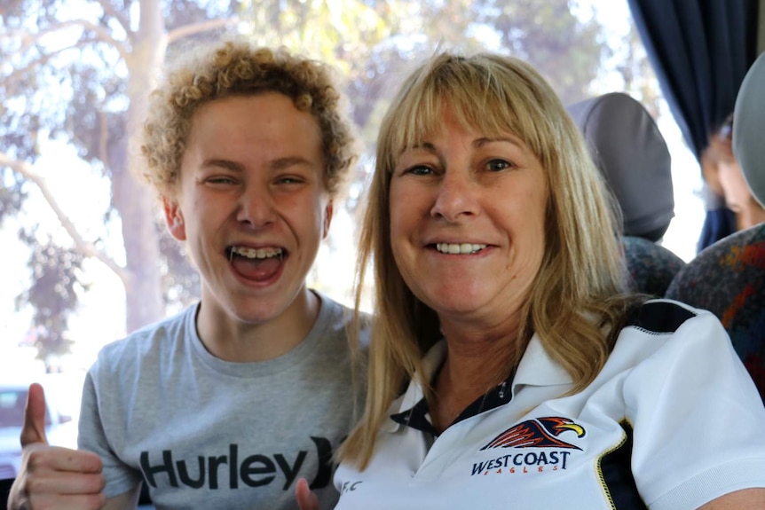 West Coast Eagles fans Nick and Alison Day are on a bus to go to the grand final at the MCG
