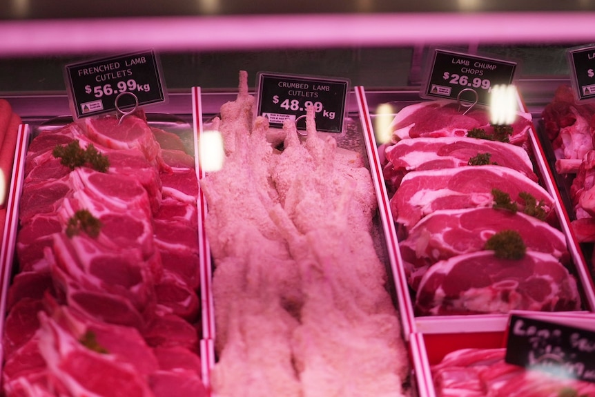 crumbed lamb cutlets with a $48.99 price tag in a butcher shop window
