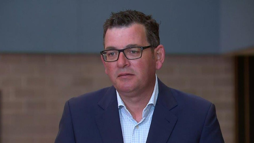 Daniel Andrews in a suit with no tie.