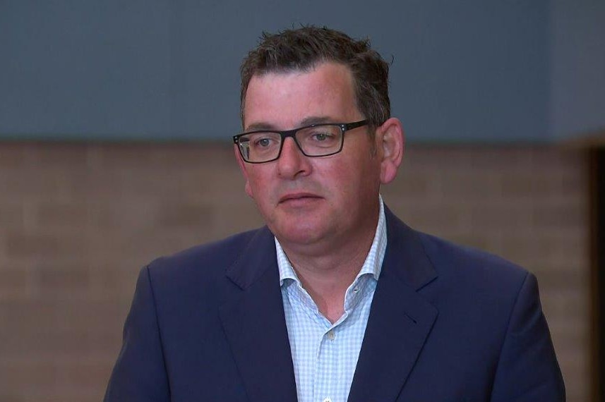 Daniel Andrews in a suit with no tie.