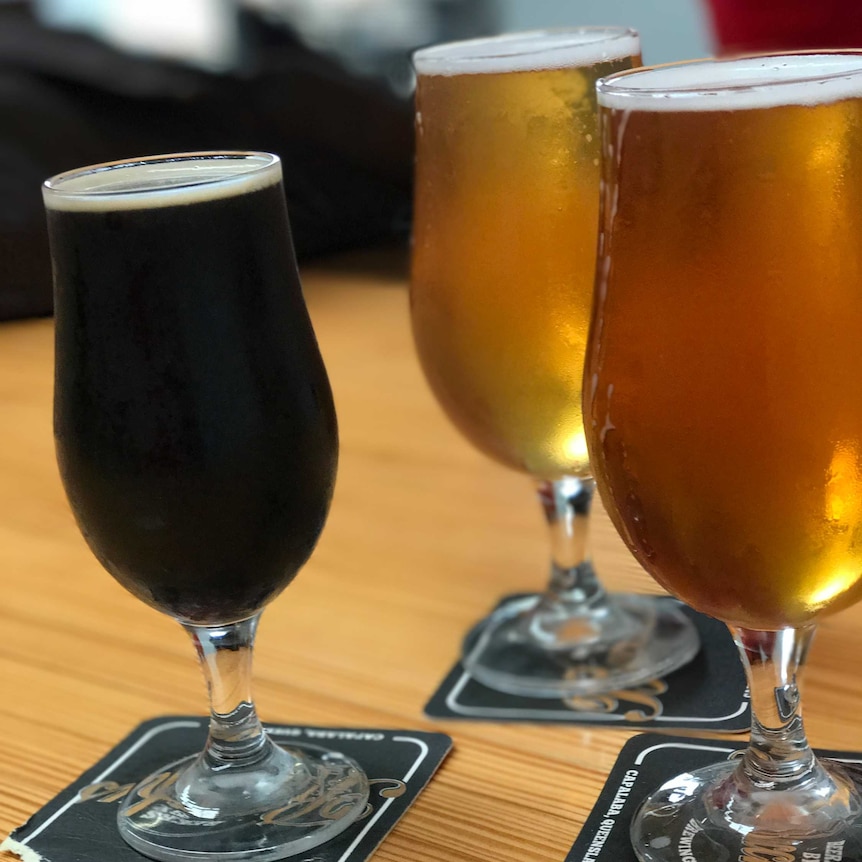 Three glasses of beer in a range of colours