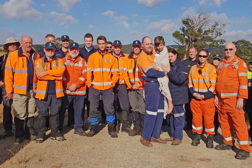 Bob Wright (in blanket) with family and search crew