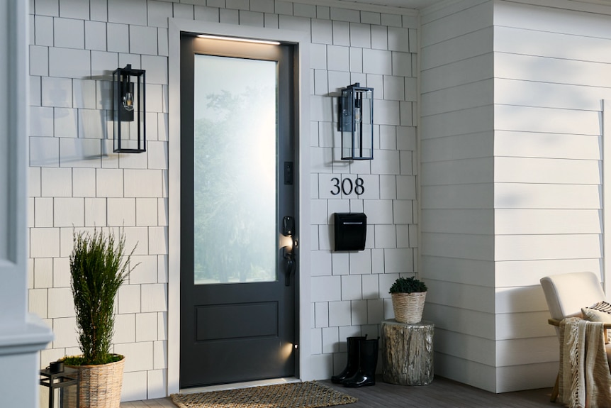 A standard-looking front door with a lock and a doorbell