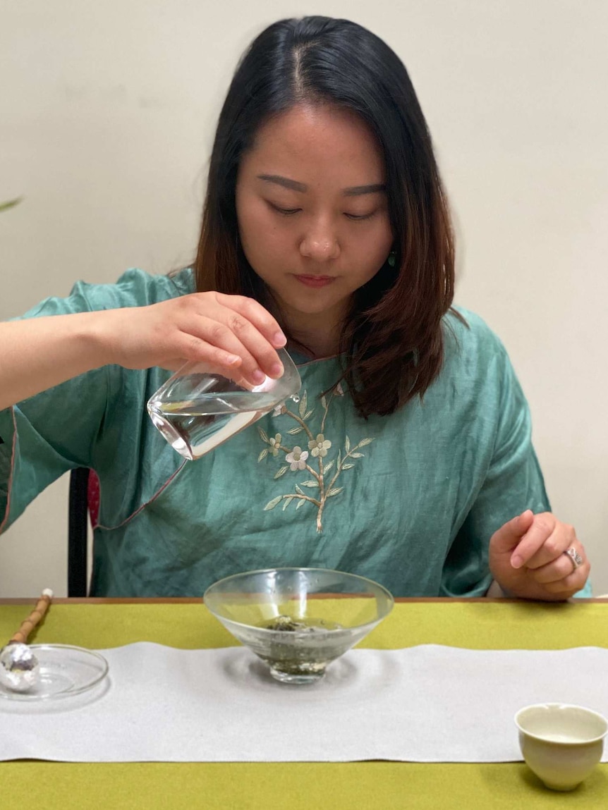 Joanne Gao partaking in a traditional tea ritual.