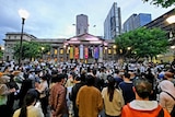 A crowd of people gather for a protest outside the state library in Melbourne CBD. 