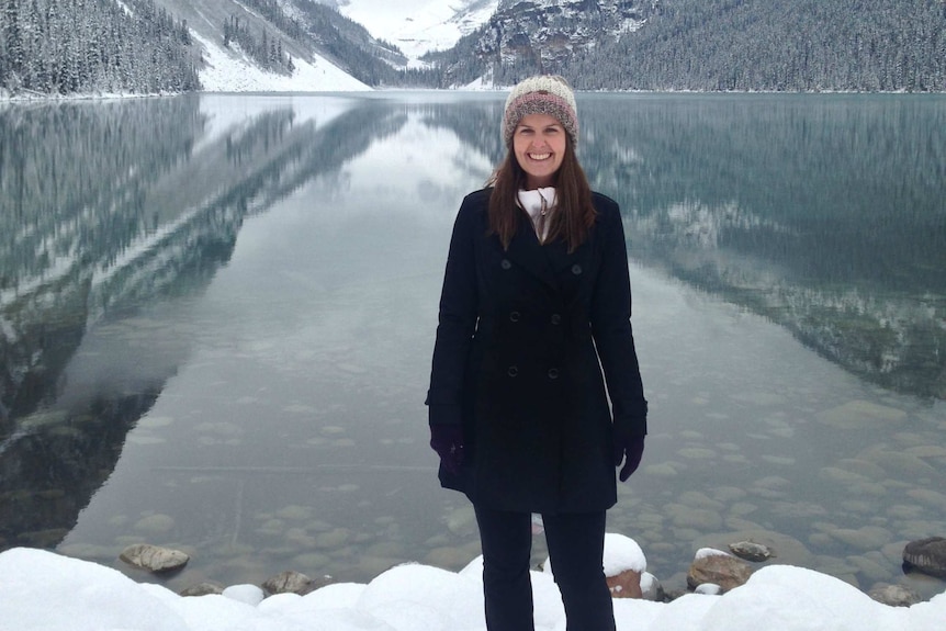 Renea Jaeger stands near a lake in the snow